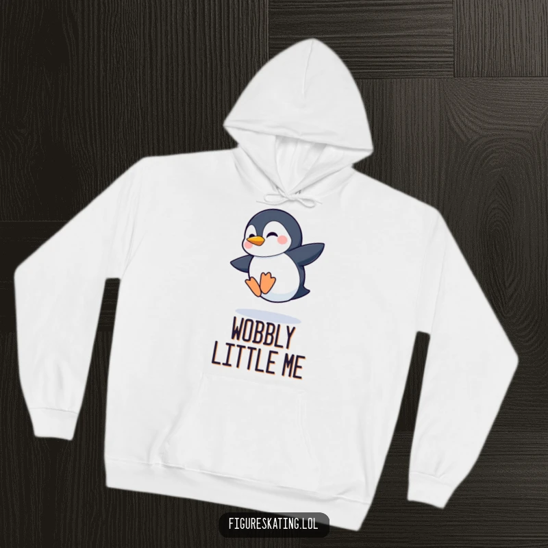 Funny hoodie design featuring a shy penguin attempting a wobbly jump with a determined grin, full of cute effort.